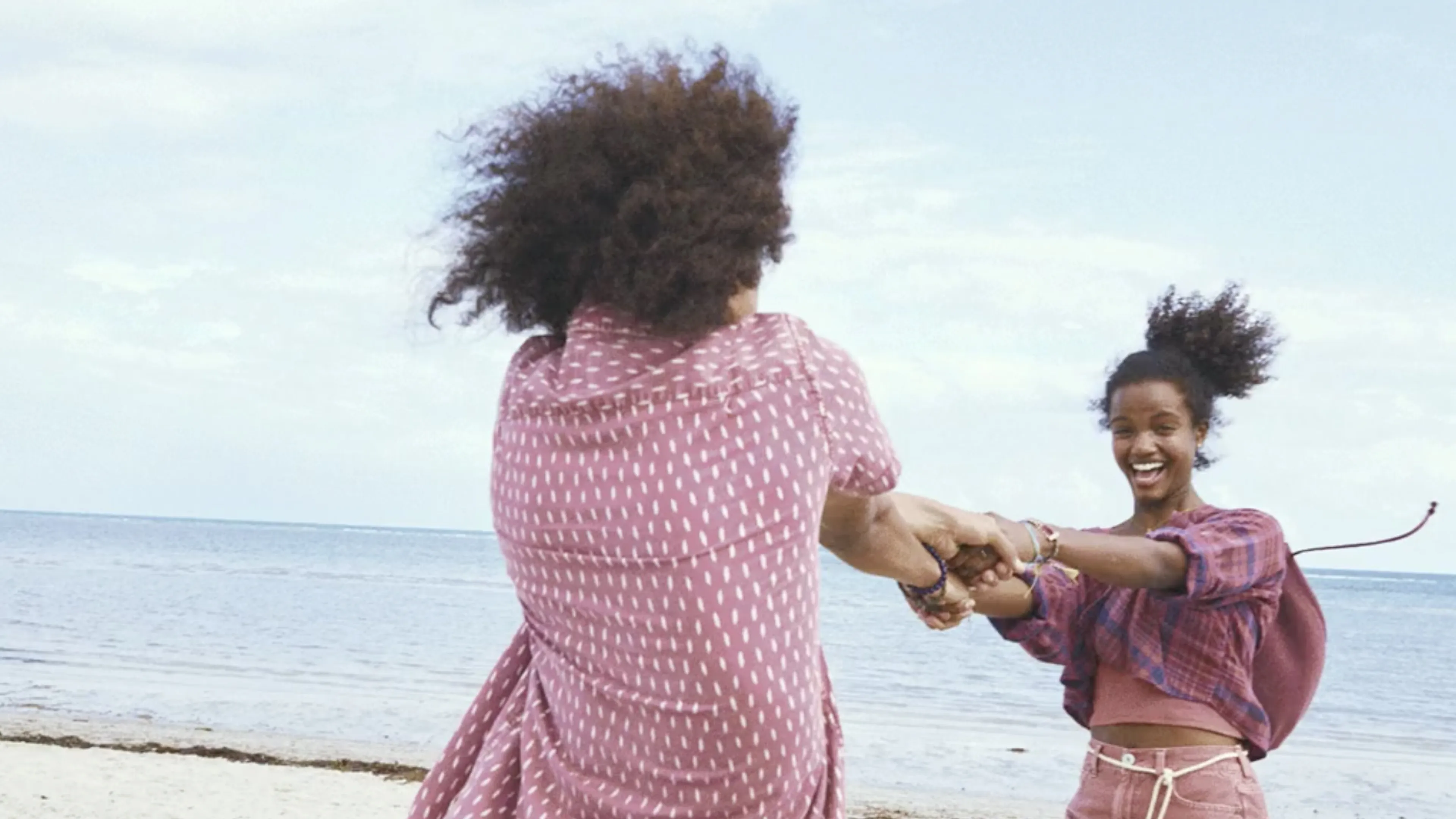 Two happy and smiling persons near a sea