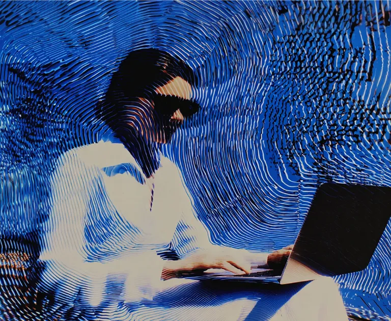 Abstract digital person with a laptop